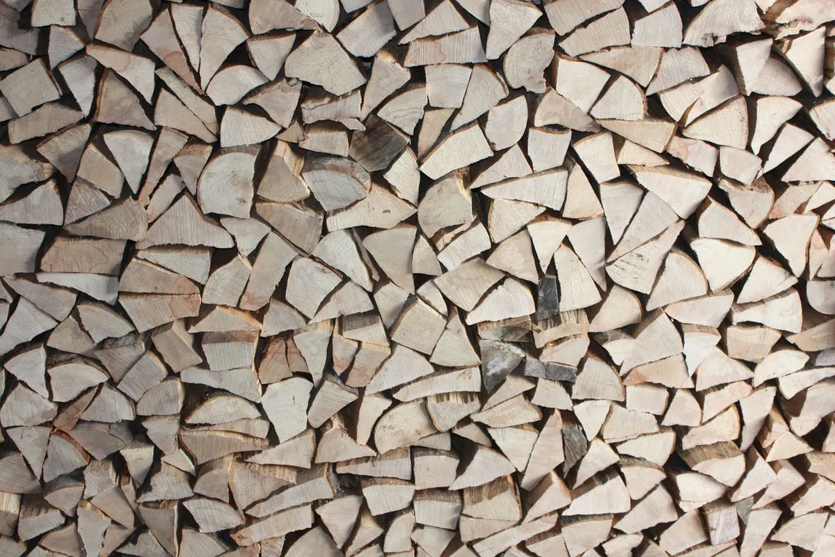 Some wood split into logs ready to burn on a Stove.